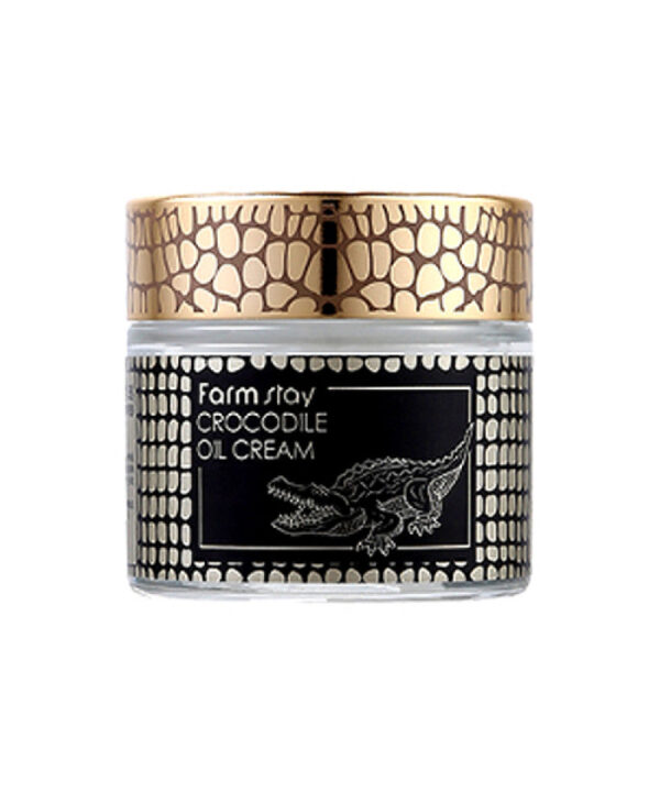 A jar of crocodile oil cream with a luxurious design, featuring a golden lid and black label with crocodile illustration.